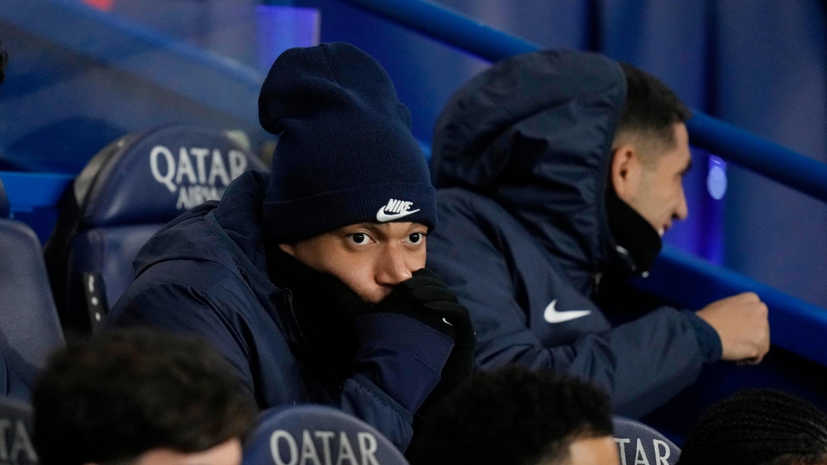 Paris St Germain’s Kylian Mbappe (centre) sits on the bench during the League 1 clash with Lille