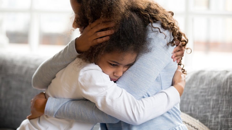A girl hugging her mother
