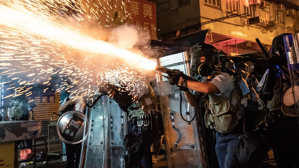 Police fire tear gas against protesters in Hong Kong on 14 August Police fire tear gas against protesters in Hong Kong on 14 August