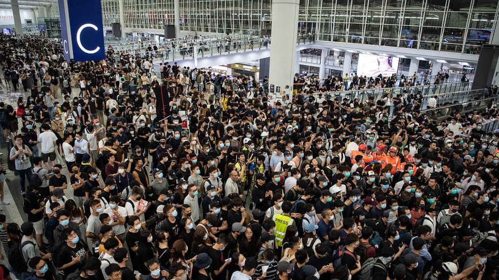 Protesters stage a sit-in at Hong Kong International Airport on 13 August 2019 Protesters stage a sit-in at Hong Kong International Airport on 13 August 2019