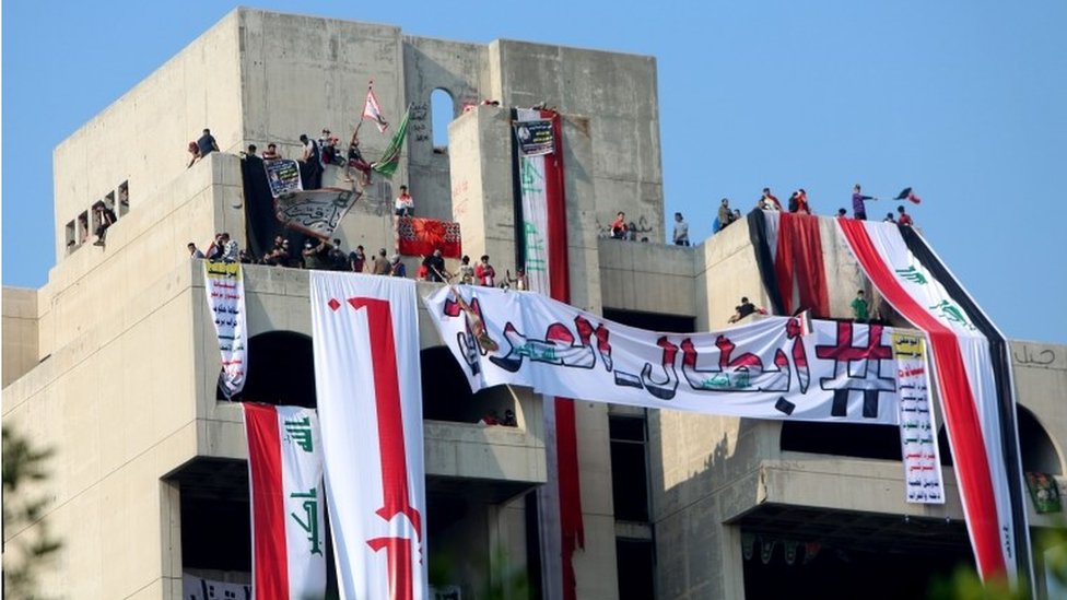 Anti-government protestors in Baghdad with banner reading: 